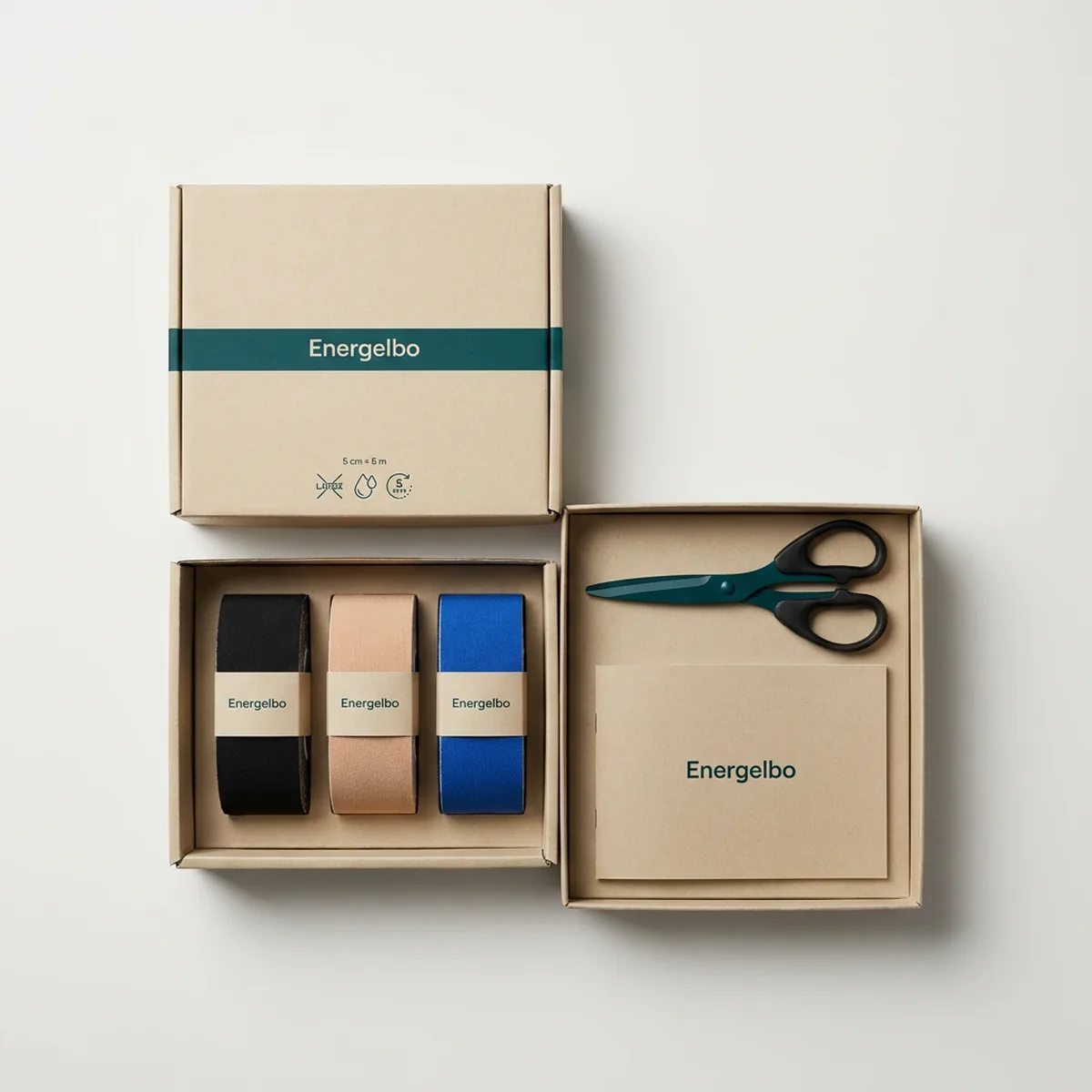 Energelbo Three-Roll Kit in an open kraft-white box: black, beige and blue tape rolls standing in a row with tape scissors and an A5 printed guide