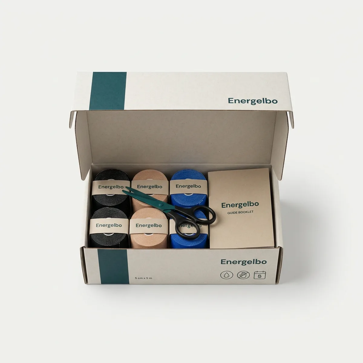 Energelbo Six-Roll Bundle in an open kraft-white box: six tape rolls in a 3 by 2 grid — two black, two beige, two blue — with tape scissors on top and the A5 guide at the side