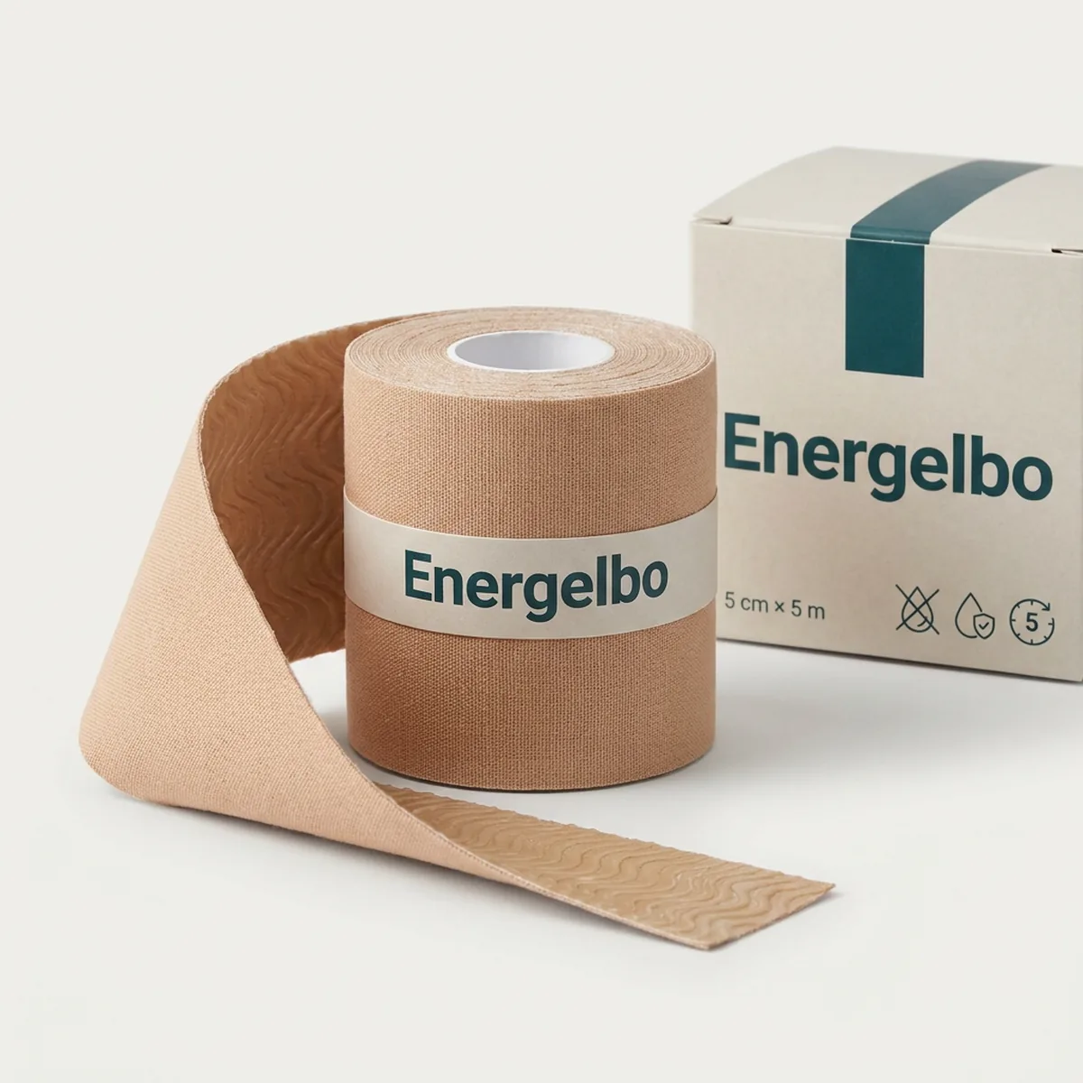 Single roll of beige Energelbo kinesiology tape, 5 cm wide, standing upright with a length of tape unrolled towards the camera